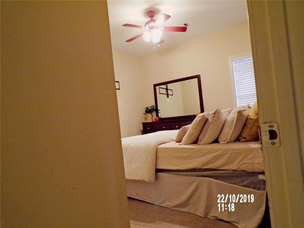 1035 Upchurch Road McDonough, GA 30252 - Photo 35 of 48 a bedroom with a bed and a chandelier