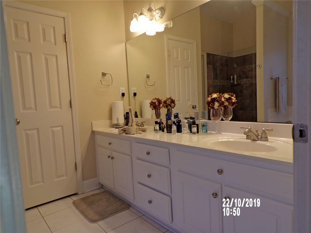 1035 Upchurch Road McDonough, GA 30252 - Photo 44 of 48 a bathroom with a double vanity sink and a mirror