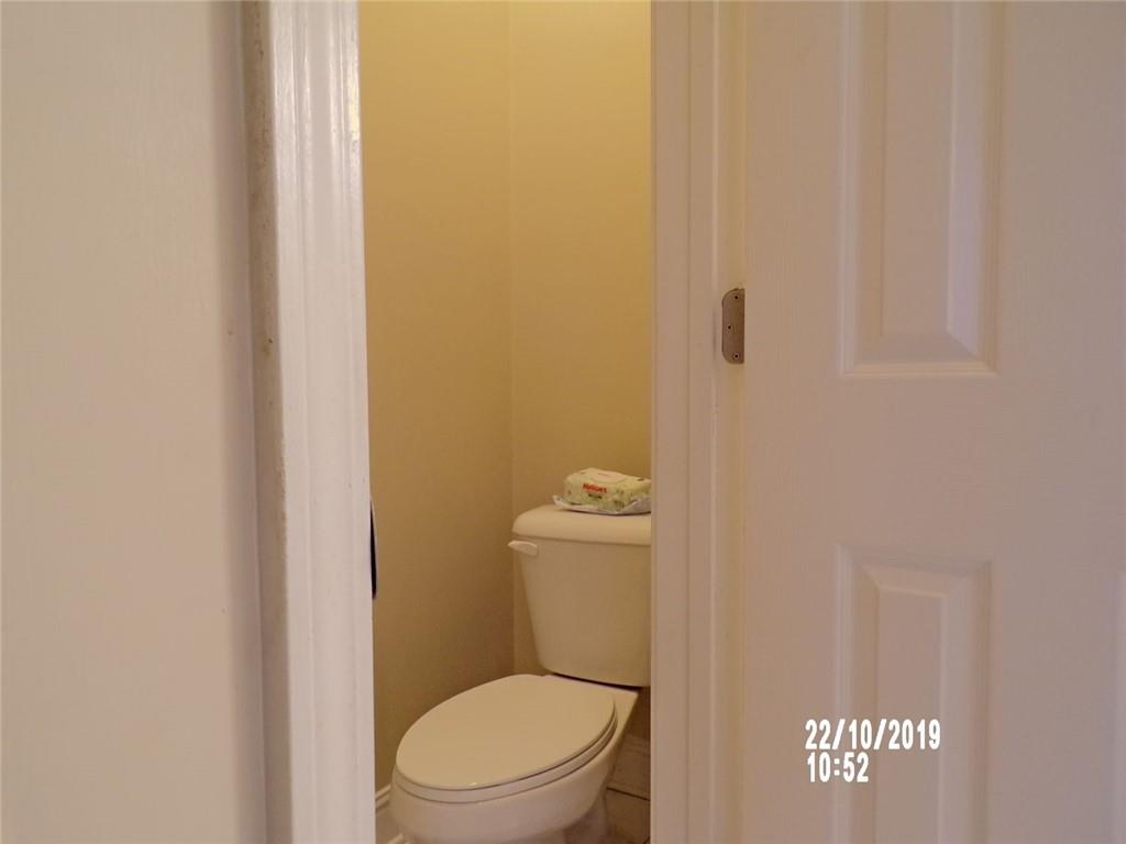1035 Upchurch Road McDonough, GA 30252 - Photo 45 of 48 a white toilet sitting next to a shower curtain