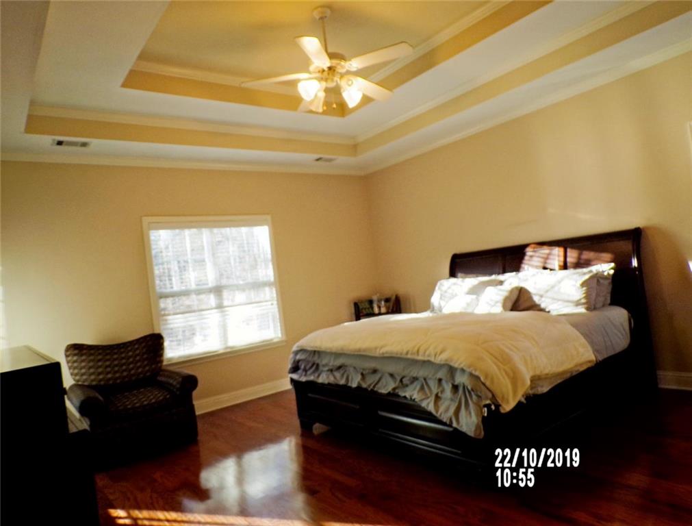 1035 Upchurch Road McDonough, GA 30252 - Photo 48 of 48 a bedroom with a bed and wooden floor