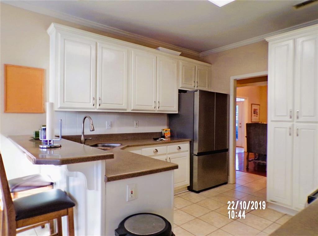 1035 Upchurch Road McDonough, GA 30252 - Photo 8 of 48 a kitchen with a sink a refrigerator and a stove top oven