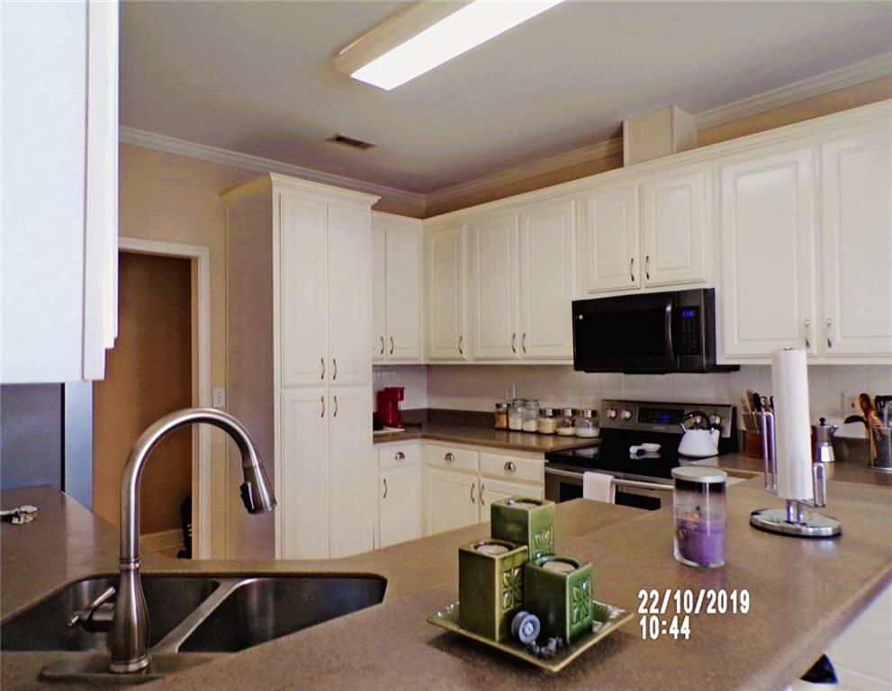 1035 Upchurch Road McDonough, GA 30252 - Photo 9 of 48 a kitchen with a sink a stove and cabinets