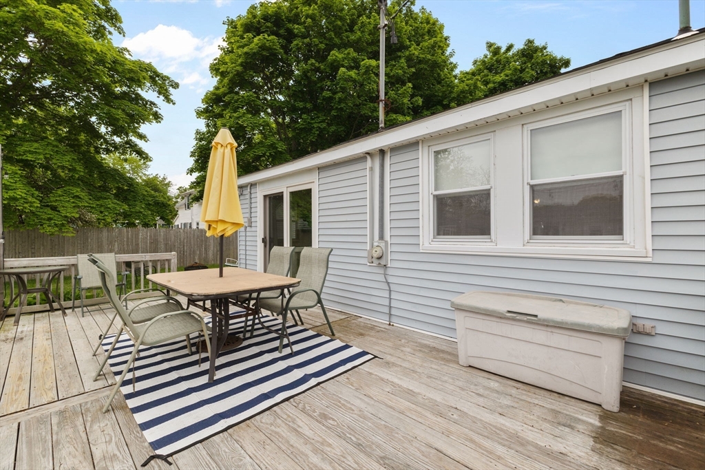 34 13th Street Wareham, MA 02558 - Photo 12 of 42 a view of a patio with table and chairs with wooden floor and fence