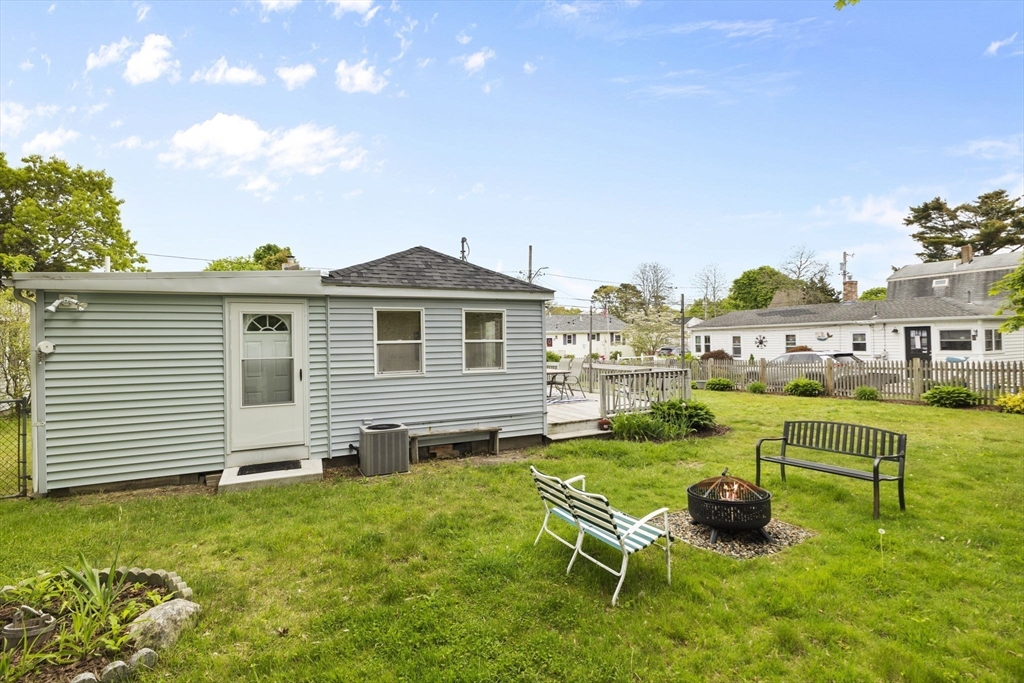 34 13th Street Wareham, MA 02558 - Photo 17 of 42 a white house with a yard table and chairs