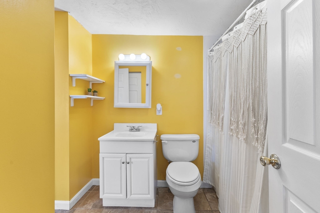 34 13th Street Wareham, MA 02558 - Photo 33 of 42 a bathroom with a sink a toilet and shower curtain