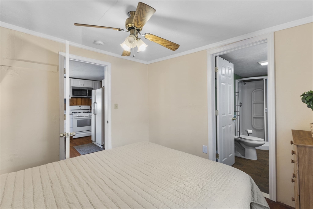 34 13th Street Wareham, MA 02558 - Photo 36 of 42 a bedroom with a bed and a chandelier