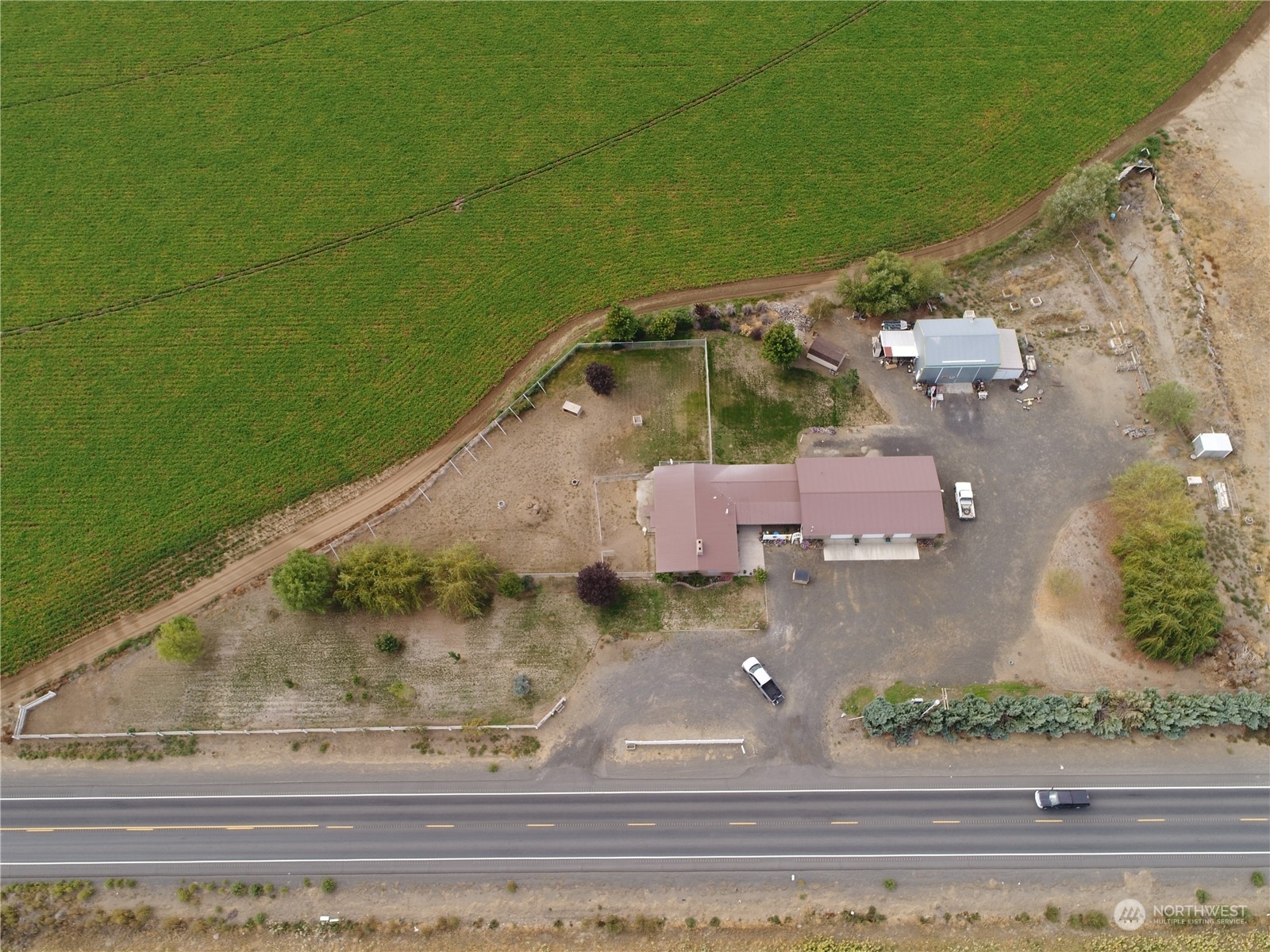 an aerial view of a house with a yard