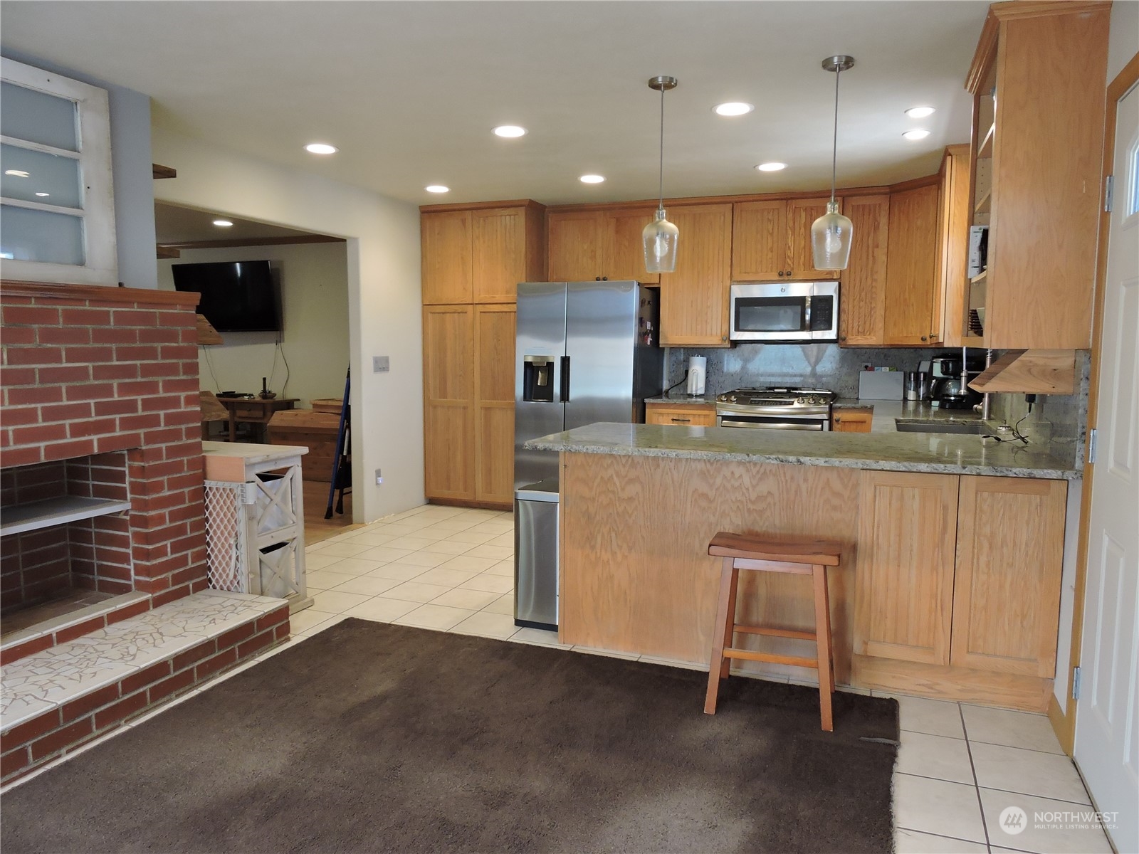 1402 Adams Road North Quincy, WA 98848 - Photo 11 of 39 a kitchen with kitchen island granite countertop a sink and a stove top oven