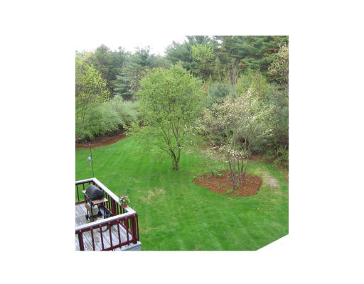 271 Hoyts Wharf Road Groton, MA 01450 - Photo 2 of 8 a backyard of a house with a yard and outdoor seating