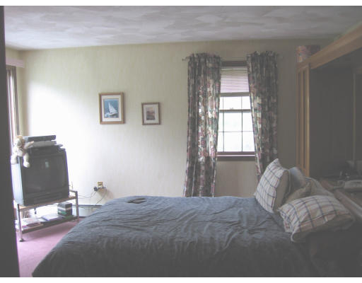 271 Hoyts Wharf Road Groton, MA 01450 - Photo 7 of 8 a bedroom with a bed and a window