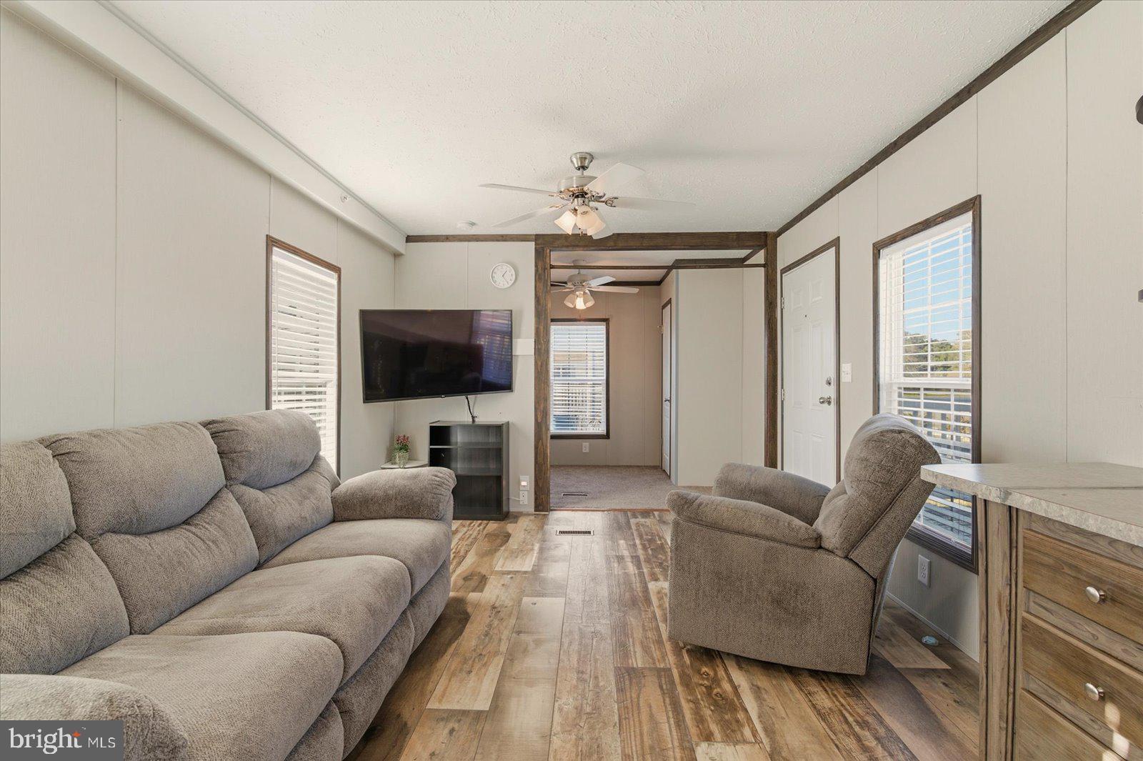 12346 Old Bridge Road, Unit 112 Ocean City, MD 21842 - Photo 11 of 72 a living room with furniture and a flat screen tv
