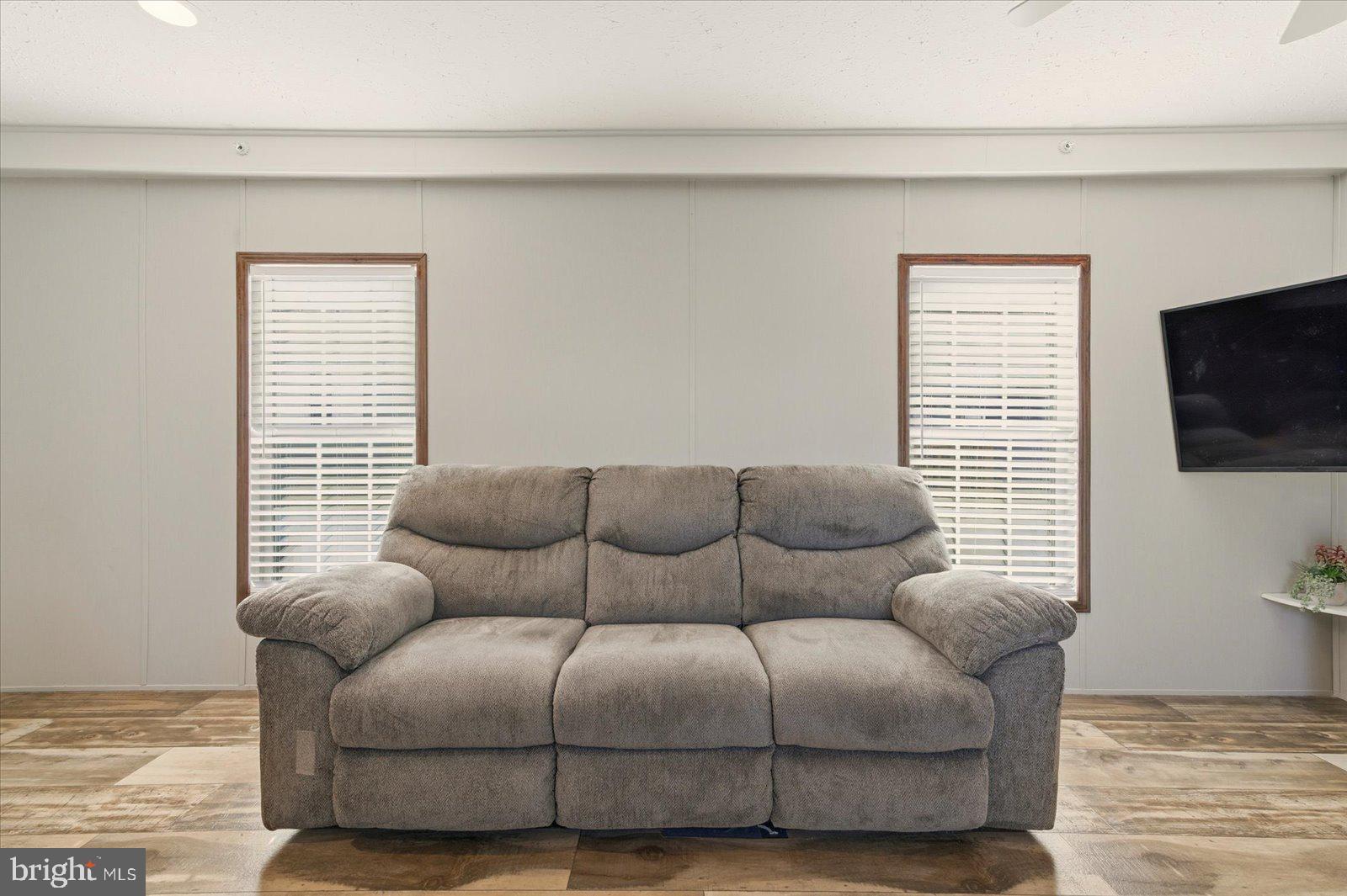 12346 Old Bridge Road, Unit 112 Ocean City, MD 21842 - Photo 12 of 72 a living room with furniture and a flat screen tv