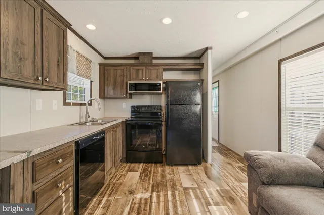 a kitchen with a refrigerator stove and sink