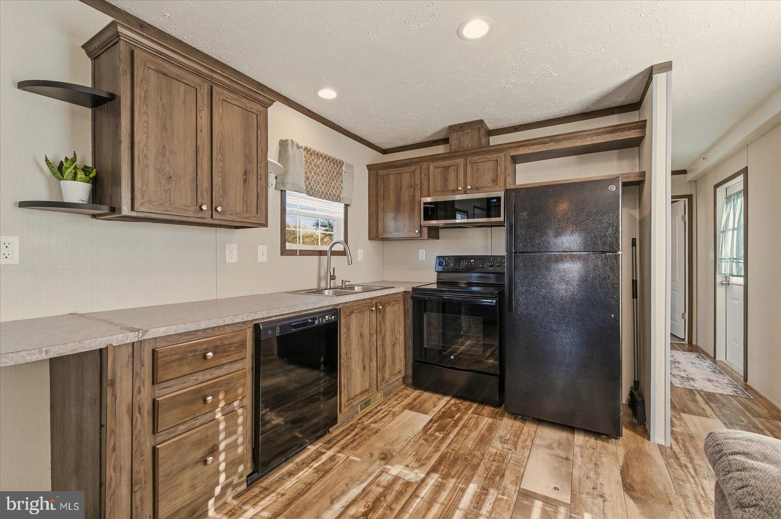 12346 Old Bridge Road, Unit 112 Ocean City, MD 21842 - Photo 15 of 72 a kitchen with a refrigerator stove and sink
