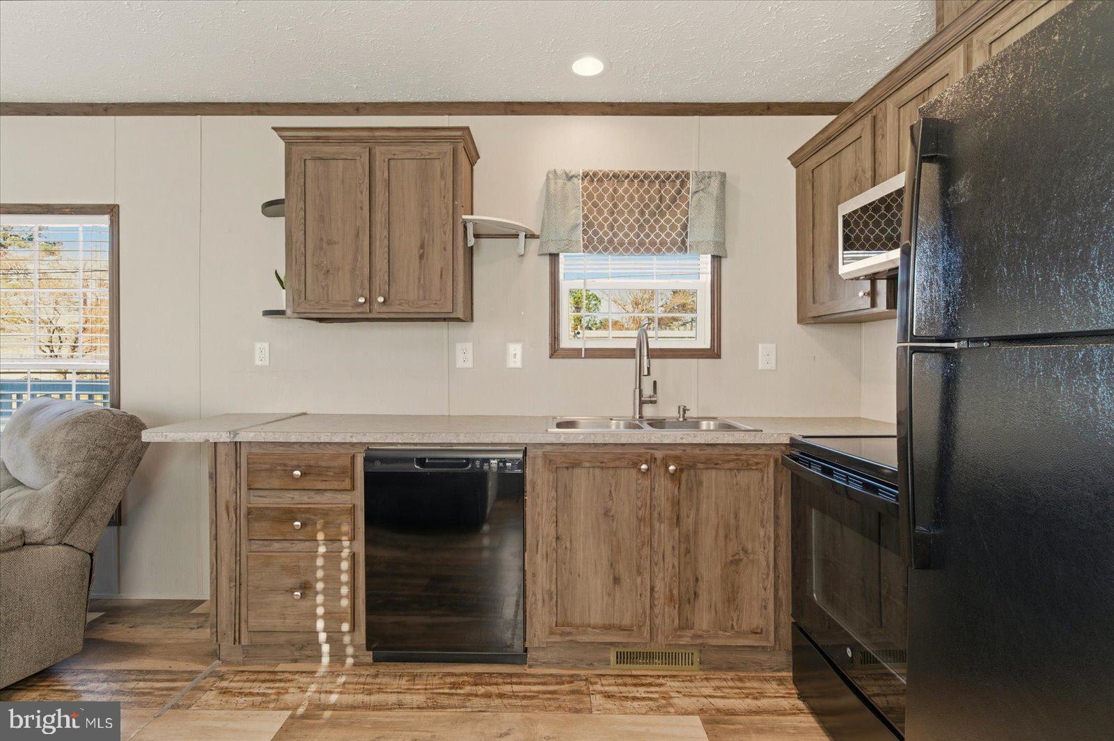 12346 Old Bridge Road, Unit 112 Ocean City, MD 21842 - Photo 16 of 72 a kitchen with stainless steel appliances granite countertop a sink stove and refrigerator