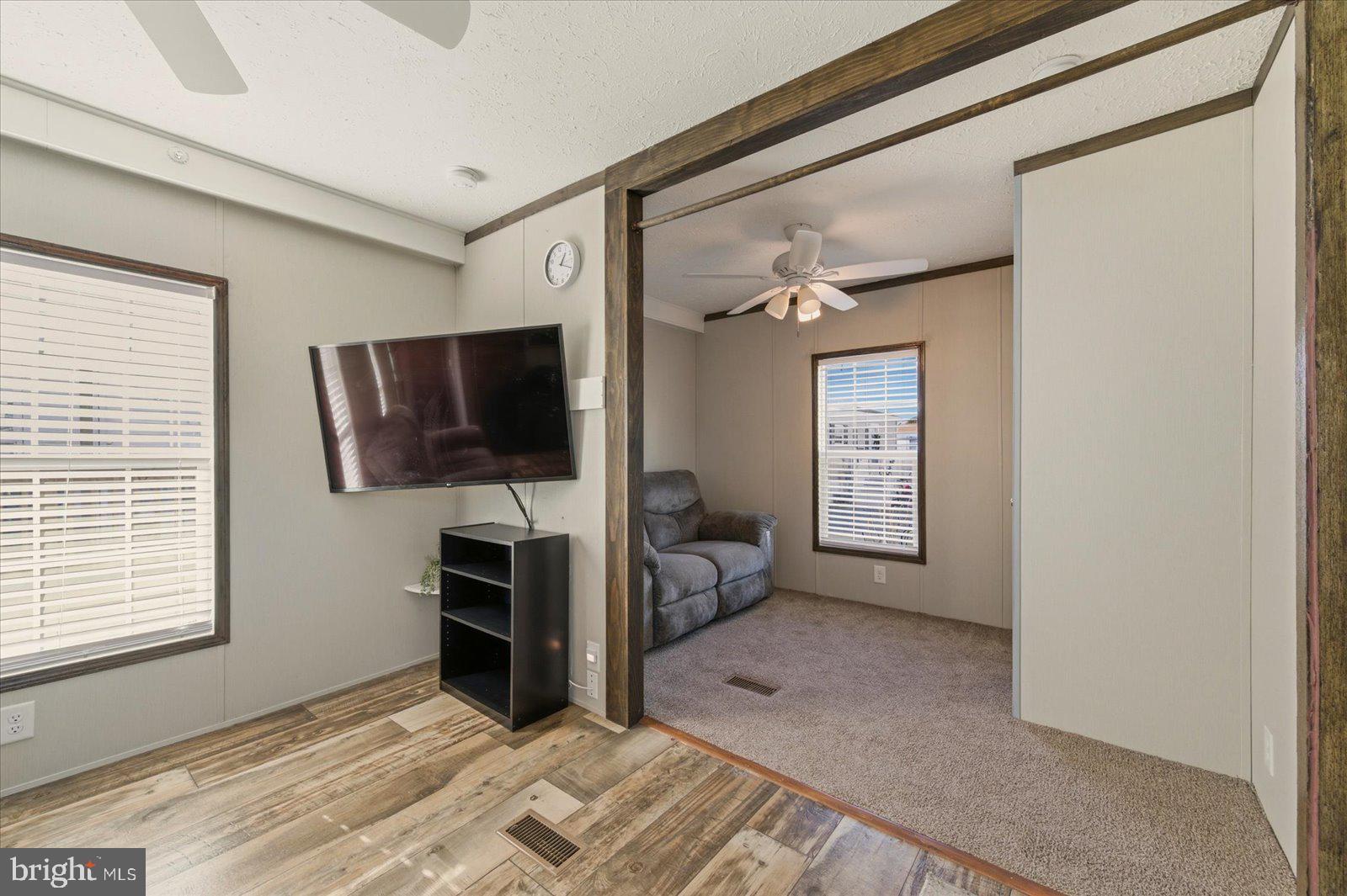 12346 Old Bridge Road, Unit 112 Ocean City, MD 21842 - Photo 20 of 72 a view of a livingroom with furniture and a flat screen tv