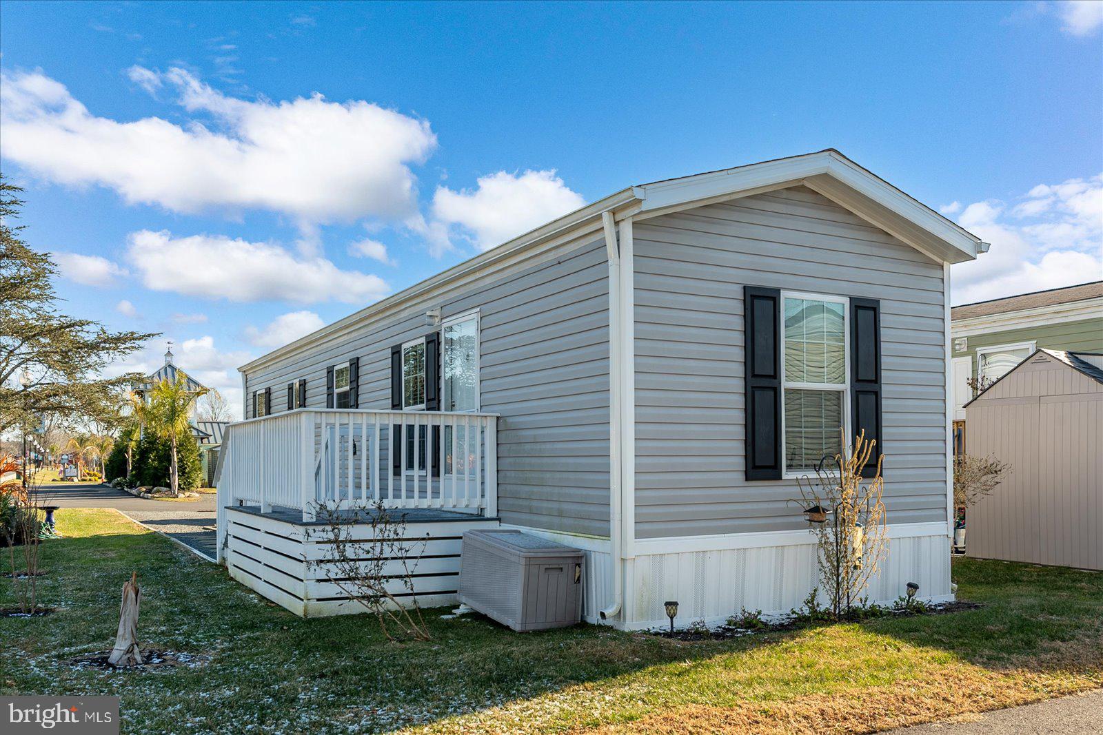 12346 Old Bridge Road, Unit 112 Ocean City, MD 21842 - Photo 2 of 72 a front view of a house with a garden