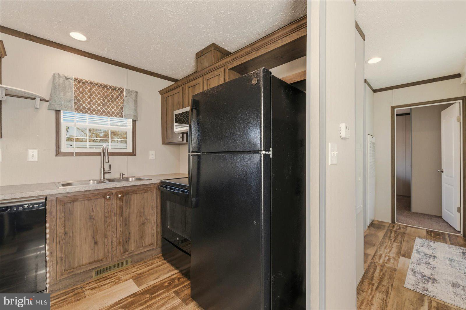 12346 Old Bridge Road, Unit 112 Ocean City, MD 21842 - Photo 24 of 72 a kitchen with a refrigerator and a sink