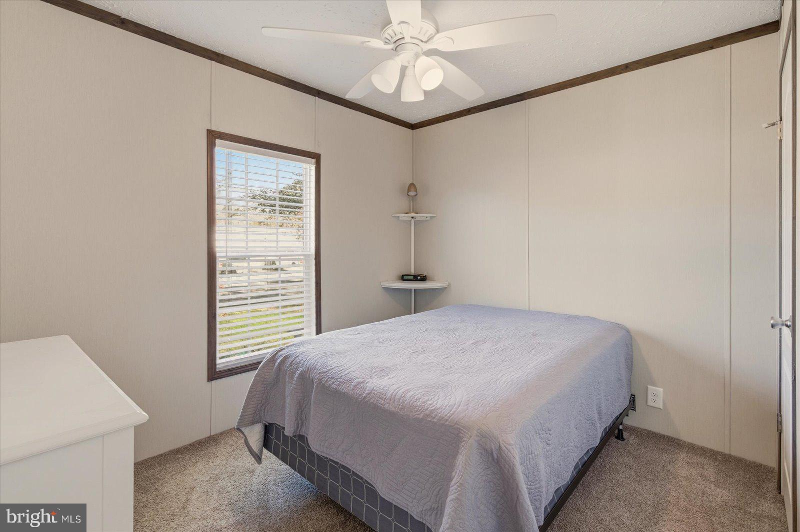 12346 Old Bridge Road, Unit 112 Ocean City, MD 21842 - Photo 25 of 72 a bedroom with a bed and a window