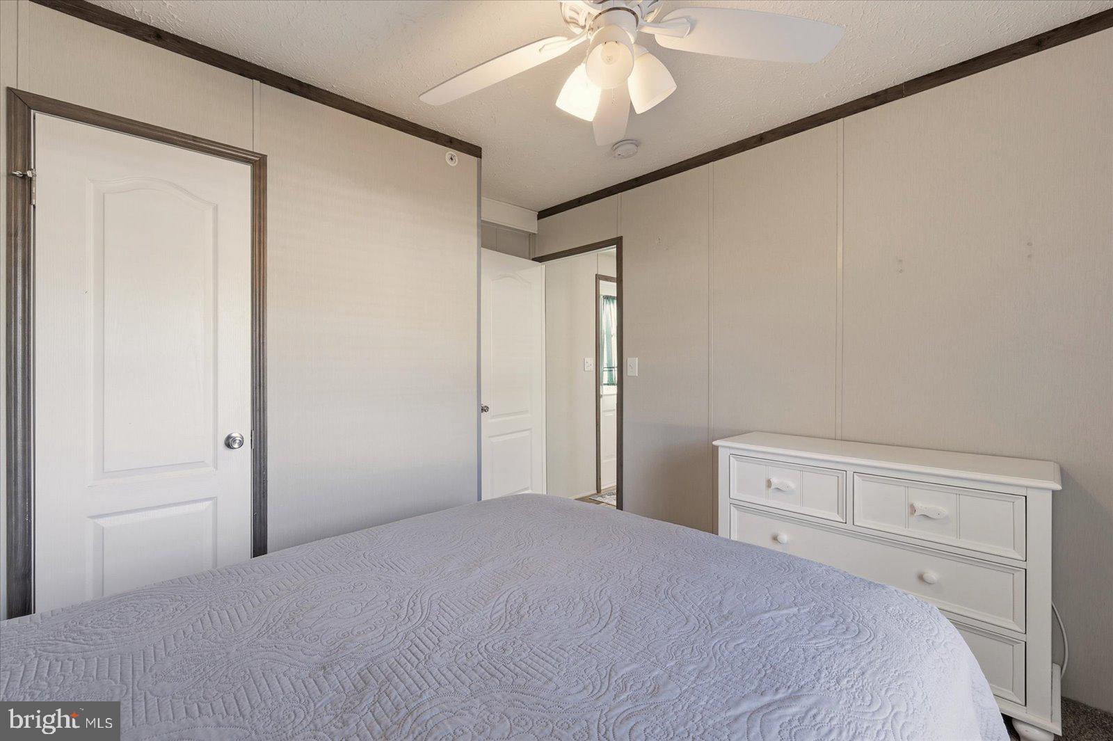 12346 Old Bridge Road, Unit 112 Ocean City, MD 21842 - Photo 28 of 72 a bedroom with a bed and a chandelier