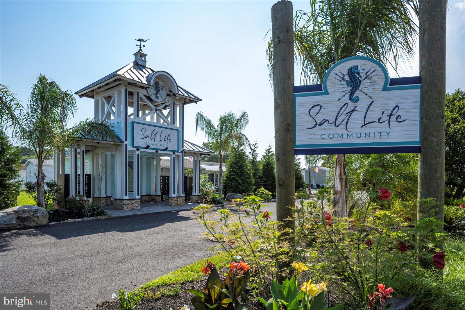 12346 Old Bridge Road, Unit 112 Ocean City, MD 21842 - Photo 41 of 72 a front view of a building with garden