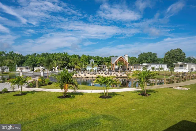 an aerial view of a house with swimming pool and lake view