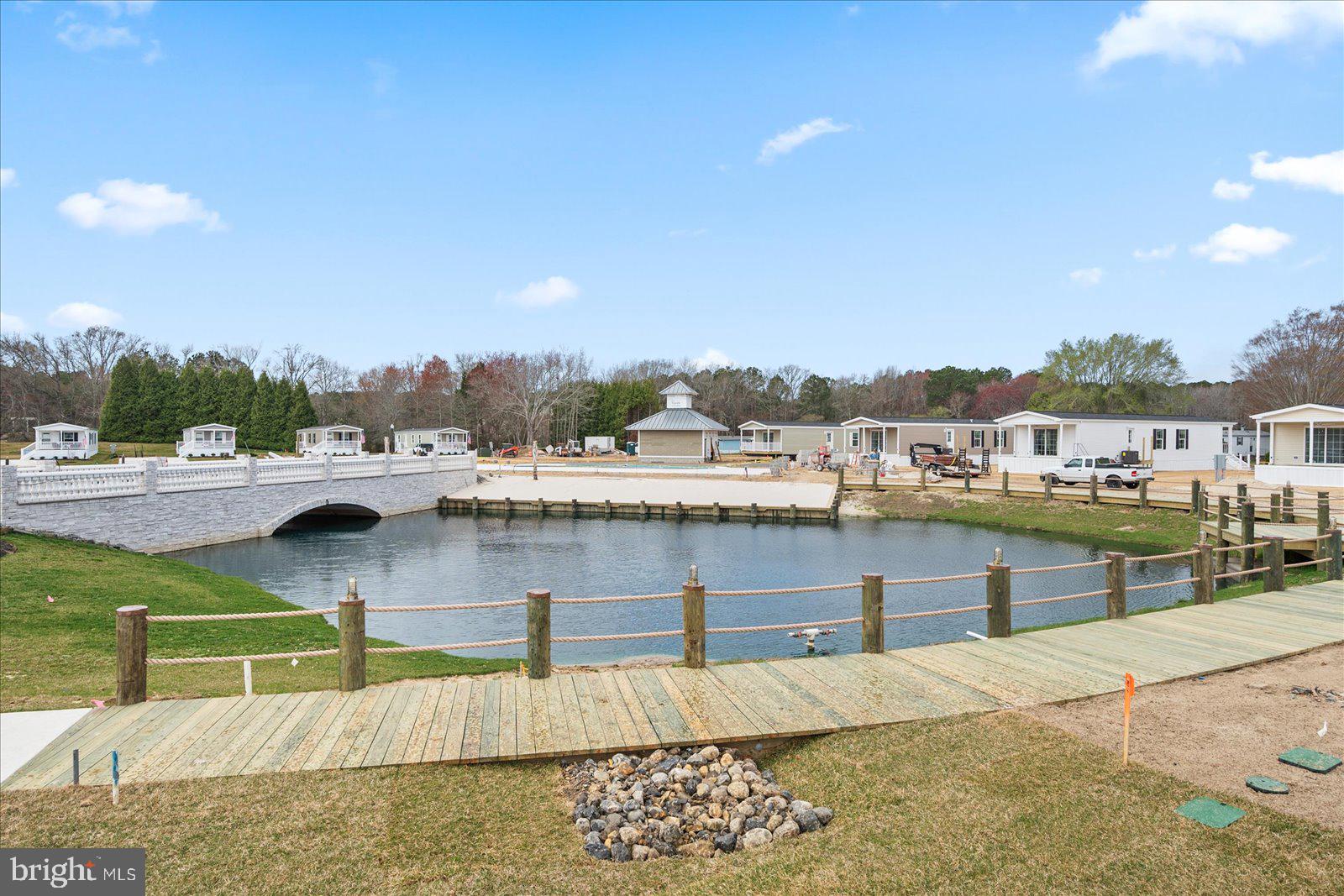 12346 Old Bridge Road, Unit 112 Ocean City, MD 21842 - Photo 57 of 72 a view of swimming pool with outdoor seating and lake view