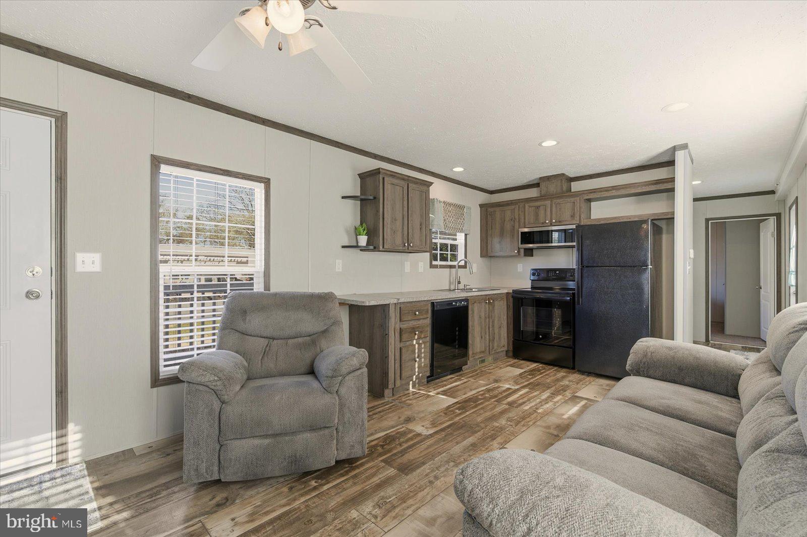 12346 Old Bridge Road, Unit 112 Ocean City, MD 21842 - Photo 6 of 72 a living room with furniture and a chandelier