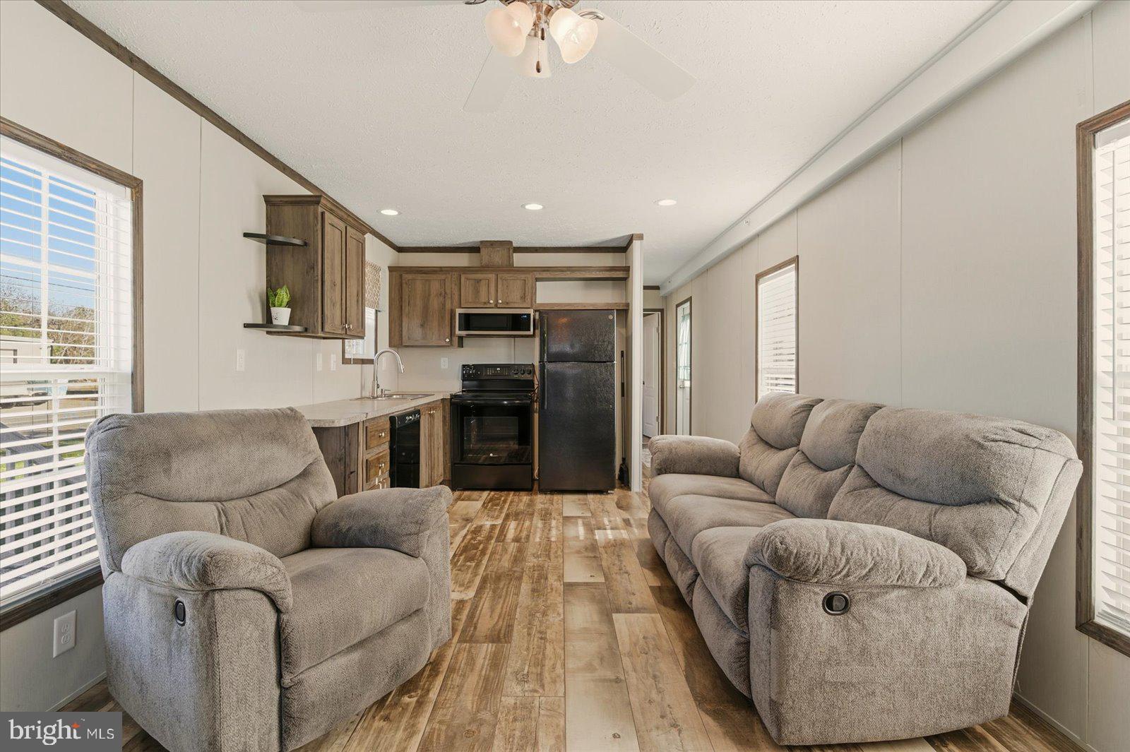 12346 Old Bridge Road, Unit 112 Ocean City, MD 21842 - Photo 7 of 72 a living room with furniture and a fireplace