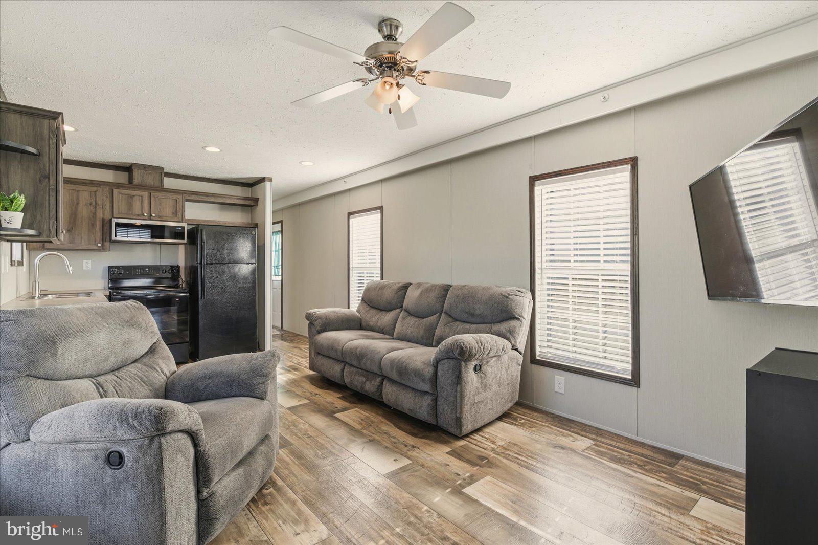 12346 Old Bridge Road, Unit 112 Ocean City, MD 21842 - Photo 8 of 72 a living room with furniture and a window