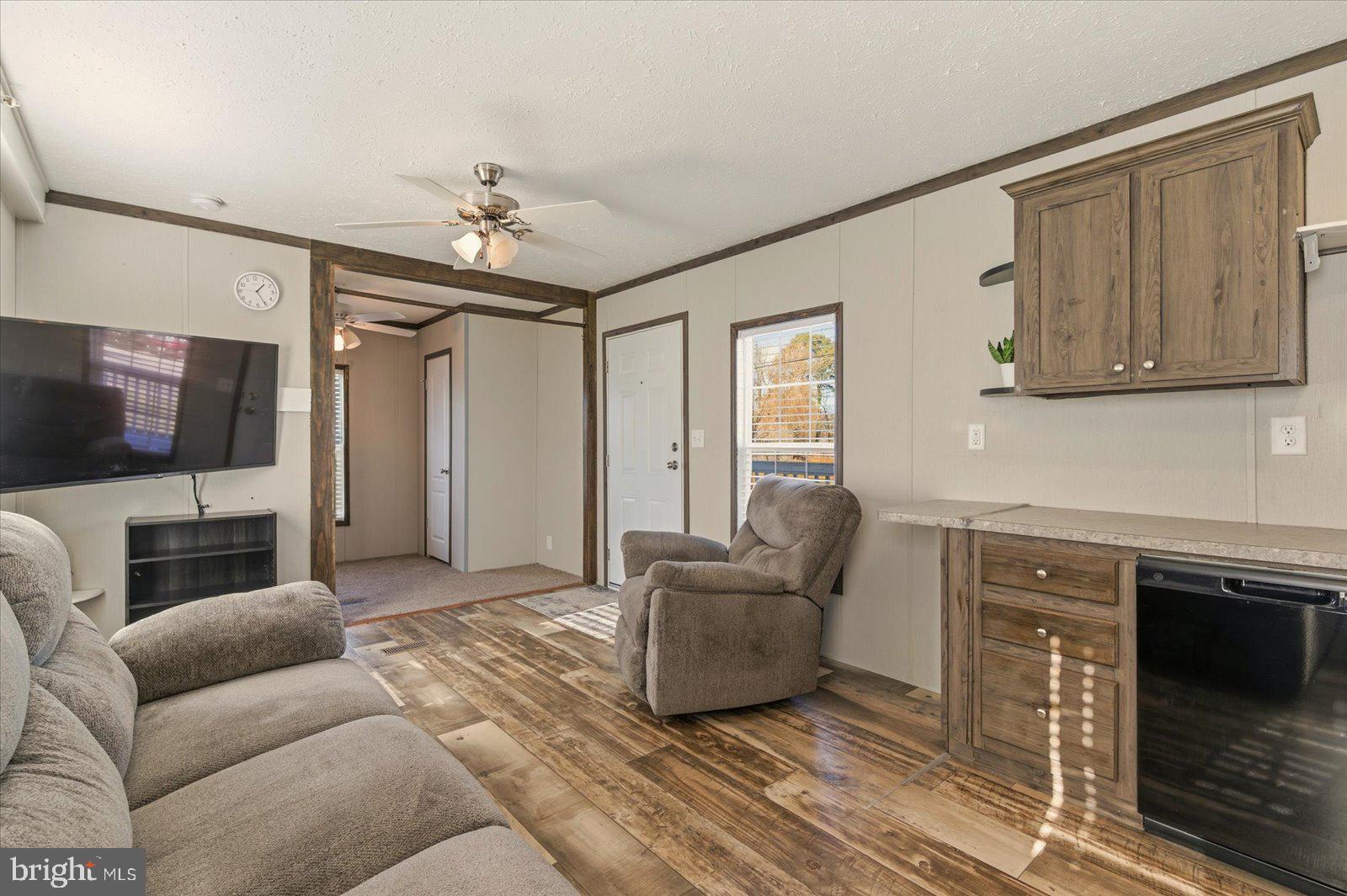 12346 Old Bridge Road, Unit 112 Ocean City, MD 21842 - Photo 9 of 72 a living room with furniture and a flat screen tv
