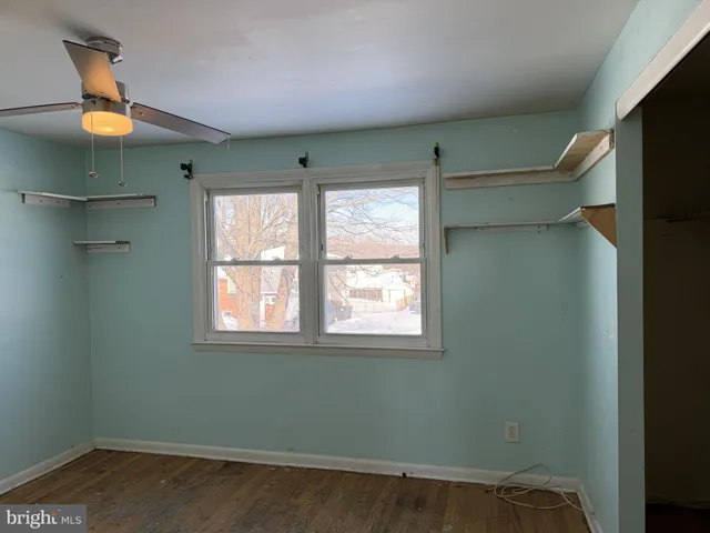 a room with a window and wooden floor