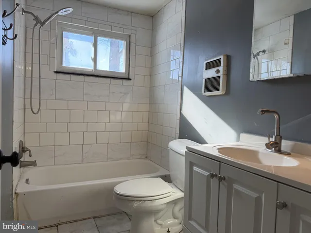 a bathroom with a sink toilet and bathtub