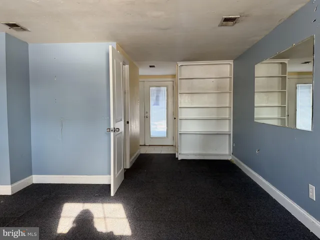 a view of empty room with closet and window