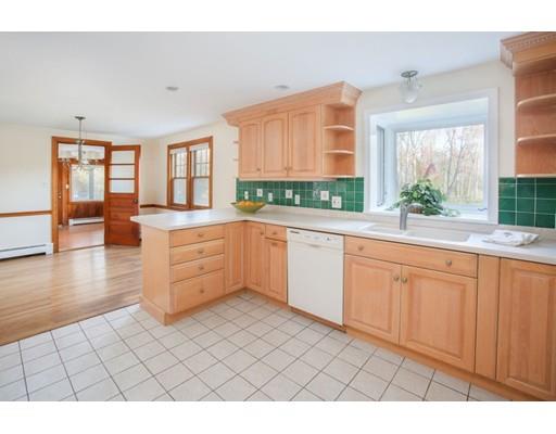 103 Page Road Lincoln, MA 01773 - Photo 2 of 12 a large white kitchen with granite countertop a sink window and cabinets