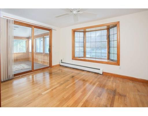 103 Page Road Lincoln, MA 01773 - Photo 4 of 12 a view of an empty room with a window and wooden floor