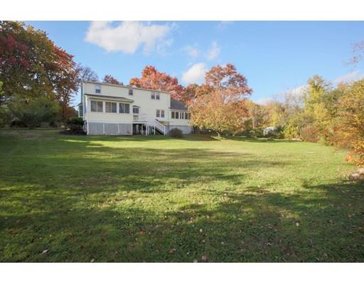 103 Page Road Lincoln, MA 01773 - Photo 6 of 12 a front view of a house with a big yard