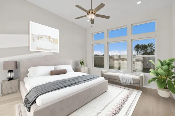 a bedroom with a large bed and a potted plant