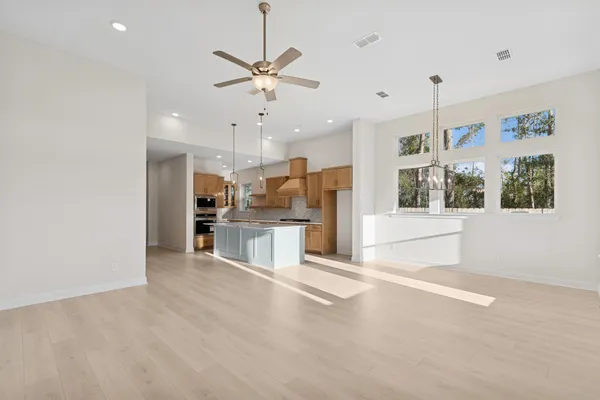 a view of a kitchen with a sink stainless steel appliances and cabinets