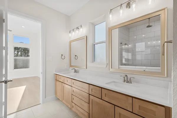 a bathroom with a granite countertop sink mirror and