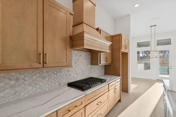 a kitchen with stainless steel appliances granite countertop a stove a sink and a refrigerator
