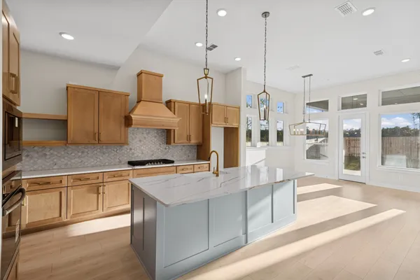 a kitchen with stainless steel appliances granite countertop a sink and a refrigerator