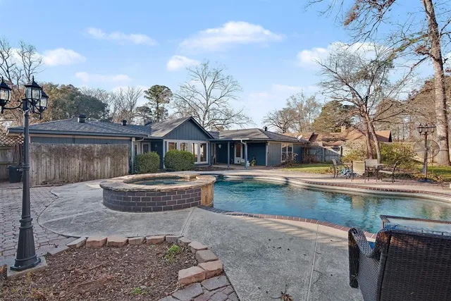 a front view of a house with swimming pool yard and outdoor seating