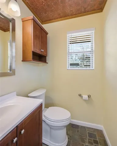 a bathroom with a toilet a sink and mirror
