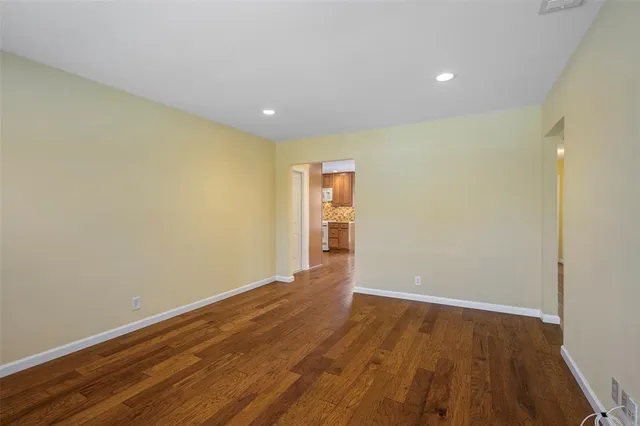 a view of room with wooden floor and natural light