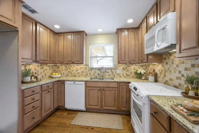 a kitchen with a sink stove and cabinets