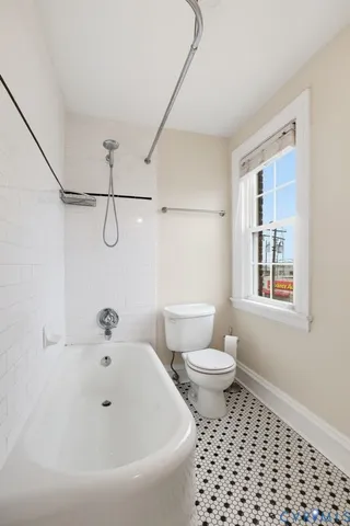 a bathroom with a bathtub and a toilet