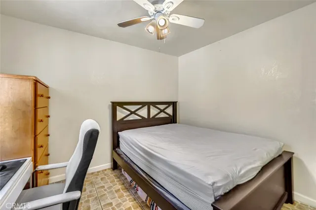 a bedroom with a bed a desk and chair