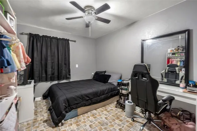 a bedroom with a bed and a desk