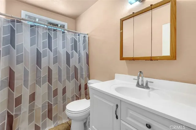 a white toilet sitting next to a white sink